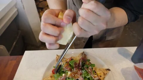 Chef Grating Fresh Parmesan Cheese Over Authentic Italian Pizza in Pizzeria Stock Footage 337677394