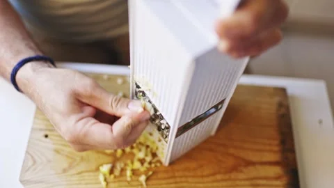 Chef grating ginger root on wooden cutting board Stock Footage 307958463