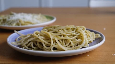 Chef grating hard cheese. Cooking pasta with pesto. A cook grater cheese Stock Footage 118073871