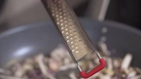 Chef grating Lime on a Mushroom Stir-Fry Stock Footage 84271192