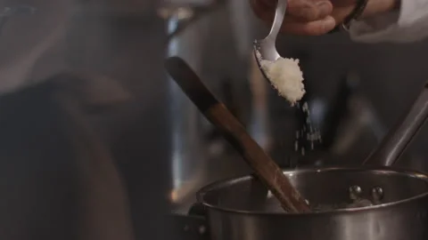 Chef grating parmesan cheese in a frying pan. French gastronomy Stock Footage 172073372