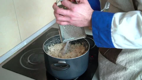 Chef grating parmesan cheese on the pasta Stock Footage 158983524