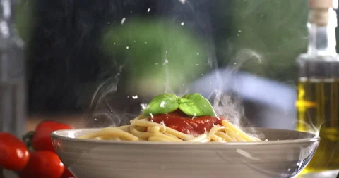 Chef grating parmesan on spaghetti with red tomato sauce in restaurant kitchen Stock-Footage 268836360