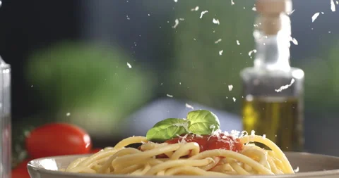 Chef grating parmesan on spaghetti with red tomato sauce in restaurant kitchen Stock Footage 268837062