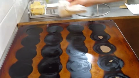 Chef Greasing and Preparing Commercial Japanese Dorayaki Pancake Pan with butter 스톡 동영상 345292569