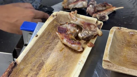 Chef grilling and serving lamb chops in a restaurant kitchen 스톡 동영상 344100294