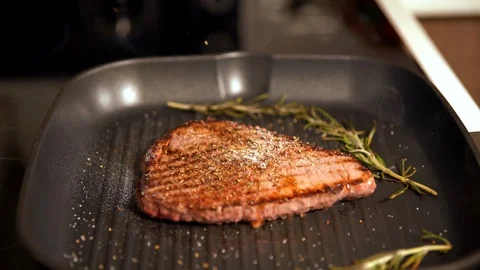 Chef grilling beef steak adding seasoning Video stock 105107176