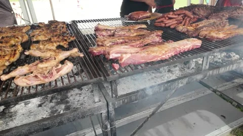 Chef grilling beef steak at barbecue dinner party outside - Close up male hands Video stock 335186159