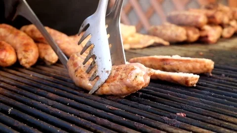 Chef Grilling, Cutting and Flipping A Sausage With Flames Stock Footage 81597513