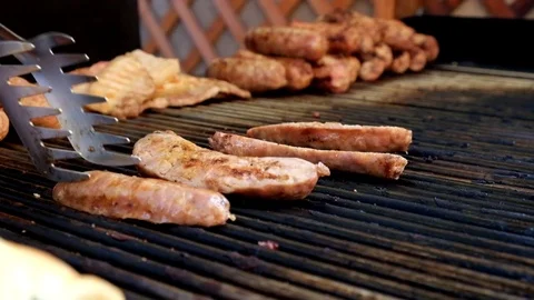 Chef Grilling, Cutting and Flipping A Sausage With Flames Stock Footage 81597535