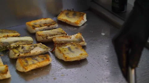 Chef grilling fish fillets with herbs on a hot surface Stock Footage 294979745