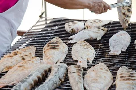 Chef grilling fish Stock Photos
