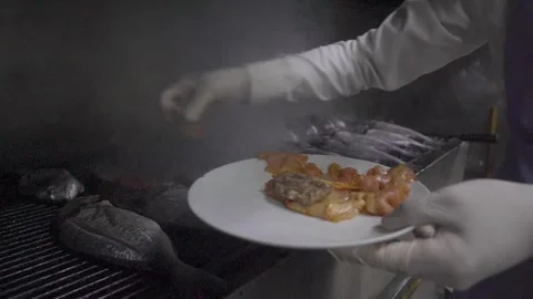 Chef grilling fresh sea bream and serving fish on plate in restaurant kitchen Stock-Footage 332116457