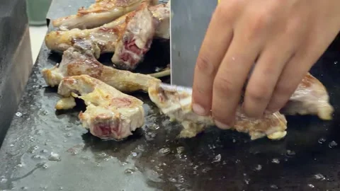 Chef grilling lamb chops and fish fillets on a flattop grill Video stock 344100275