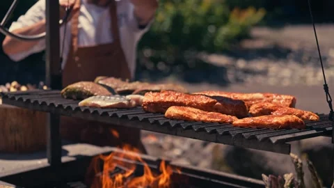 Chef Grilling Meat Seafood Vegetables Outdoor Mountains River Scenic Cinematic Video stock 280701713