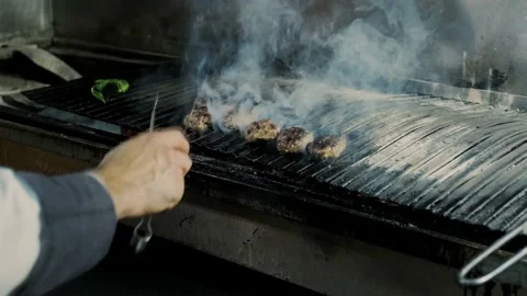The chef grilling meatballs. Fire, meatball and grill footage. Stock Footage 233066949