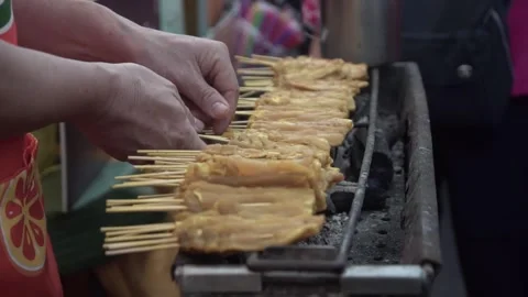 Chef grilling pork satay. slow motion. Stock Footage 250466785