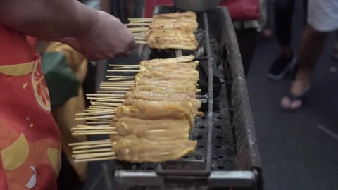 Chef grilling pork satay. slow motion. Stock Footage 250466854