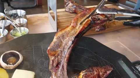 Chef Grilling Premium Tomahawk Beef Steak on Hot Teppanyaki Grill in a Restauran Stock Footage 338211026