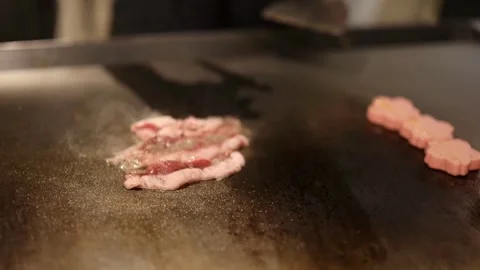 Chef grilling slices of bacon on flattop grill at commercial kitchen. 스톡 동영상 334642002