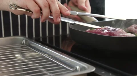 Chef is grilling steaks Stock Footage 55973404
