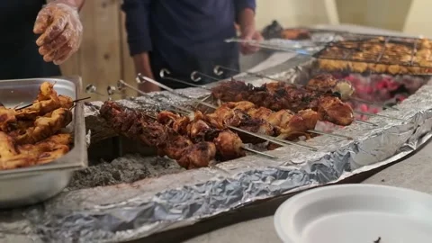 The chef grills kebabs with rice and vegetables Stock Footage 278880716