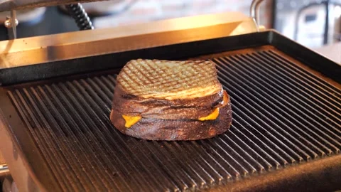 Chef grills a sandwich in a grilling machine Stock Footage 201894952