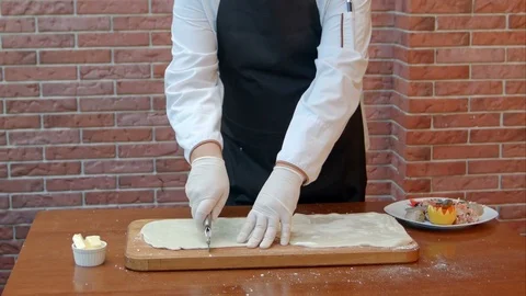 Chef hads slicing dough sheet with roller knife Stock Footage 74938086
