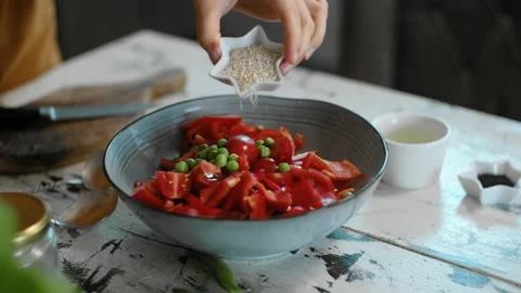 Chef hand adding sesame to fresh salad with peas Rbbro. preparing vegetarian Stock Footage 138174953