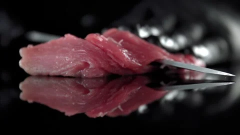 Chef hand in black glove slicing fresh raw red meat with professional steel.. Stock Footage 337602138