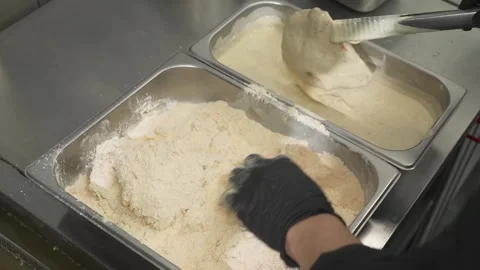 Chef Hand Breading Raw Chicken in Flour Mixture in a Commercial Kitchen Stock Footage 331633736
