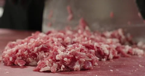 Chef hand chops meat on the cut board in the restaurant. Handmade minced meat Stock Footage 264011038