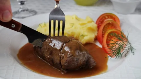 Chef hand cuts with knife beef rouladen stuffed with pickled cucumber and bacon. Video stock 263317366