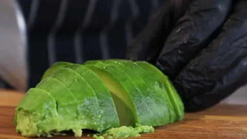 Chef hand cutting green avocado. Vegetable Ingredients. Stock Footage 152525609