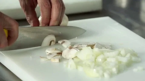 Chef hand cutting with knife champignon mushrooms 4k сlose up video Stock Footage 70197731