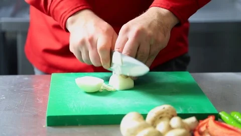 Chef hand cutting with knife onion close up, Chopped Food preparing  Stock Footage 83644020