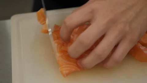 Chef hand with knife cutting salmon fillet. Stock Footage 90545609