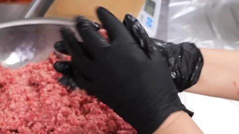 Chef hand mixing raw ground beef mince in a metal bowl, close-up shot. Stock Footage 331632845