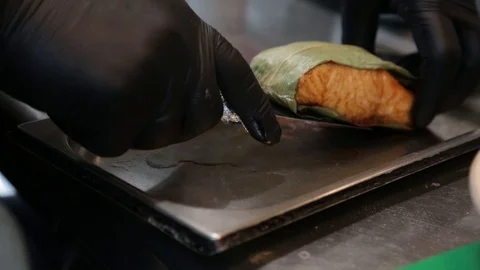 Chef hand puts fried fish and other seafood into a plate Stock Footage 123833407