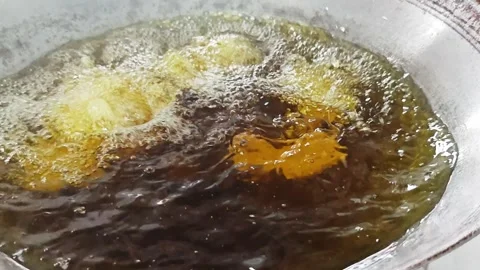 Chef hand putting raw battered fish into hot frying oil. Stock Footage 342687190