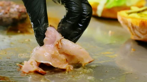 Chef hand takes sliced ham with spatula from hot grill closeup Stock Footage 325030878