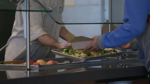 Chef handing someone vegetables on a tray Stock Footage 103881429