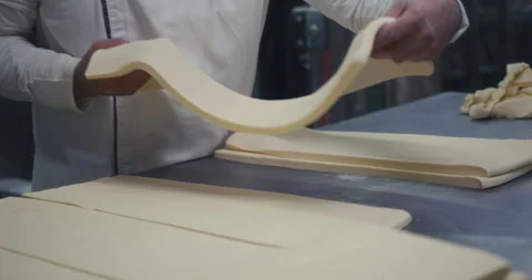 Chef handling dough sheets in industrial kitchen Stock Footage 317579840