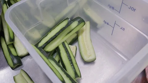 Chef Handling Fresh Cucumbers During Food Preparation Vidéo 340381856
