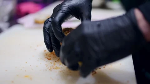 Chef handling a fried sushi roll on a white cutting board, black gloves, crispy Video stock 293488259