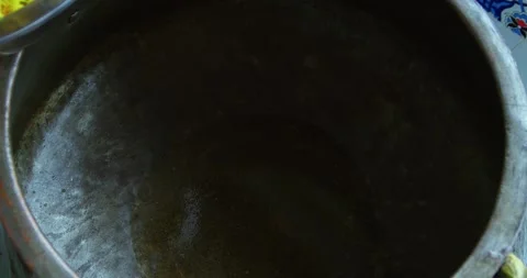 Chef hands adding chopped carrots into kazan for plov, close up Stock Footage 329618932