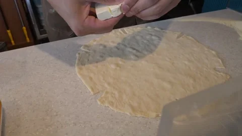 Chef Hands Adding Fresh Mozzarella Pieces to Raw Italian Pizza Dough Base Stockbeeldmateriaal 337677341