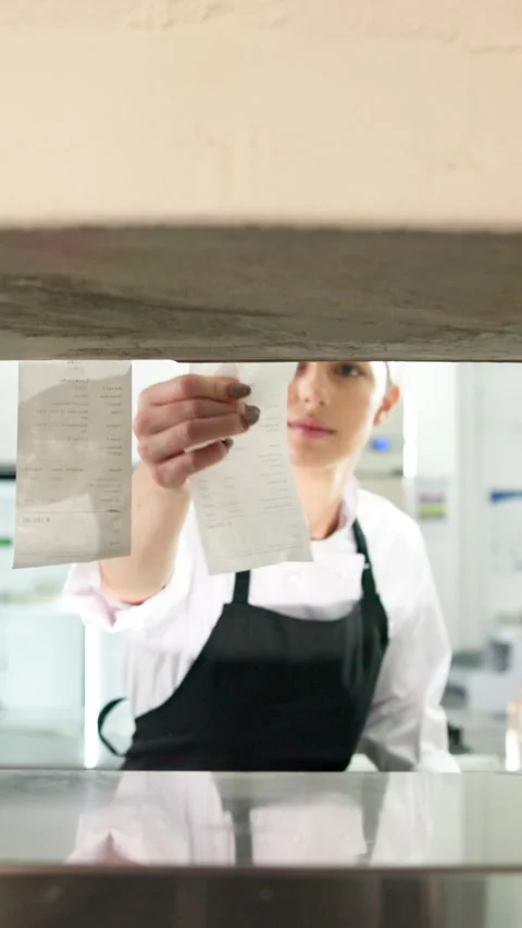 Chef, hands and reading in restaurant kitchen with receipt, customer order and Stock Footage 327268787