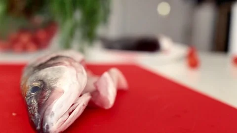 Chef hands are cutting fresh fish on fillets with knife Stock Footage 71159381