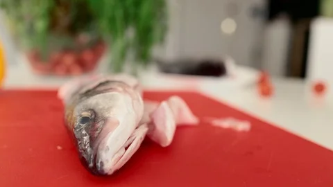Chef hands are cutting fresh fish on fillets with knife Stock Footage 71159828